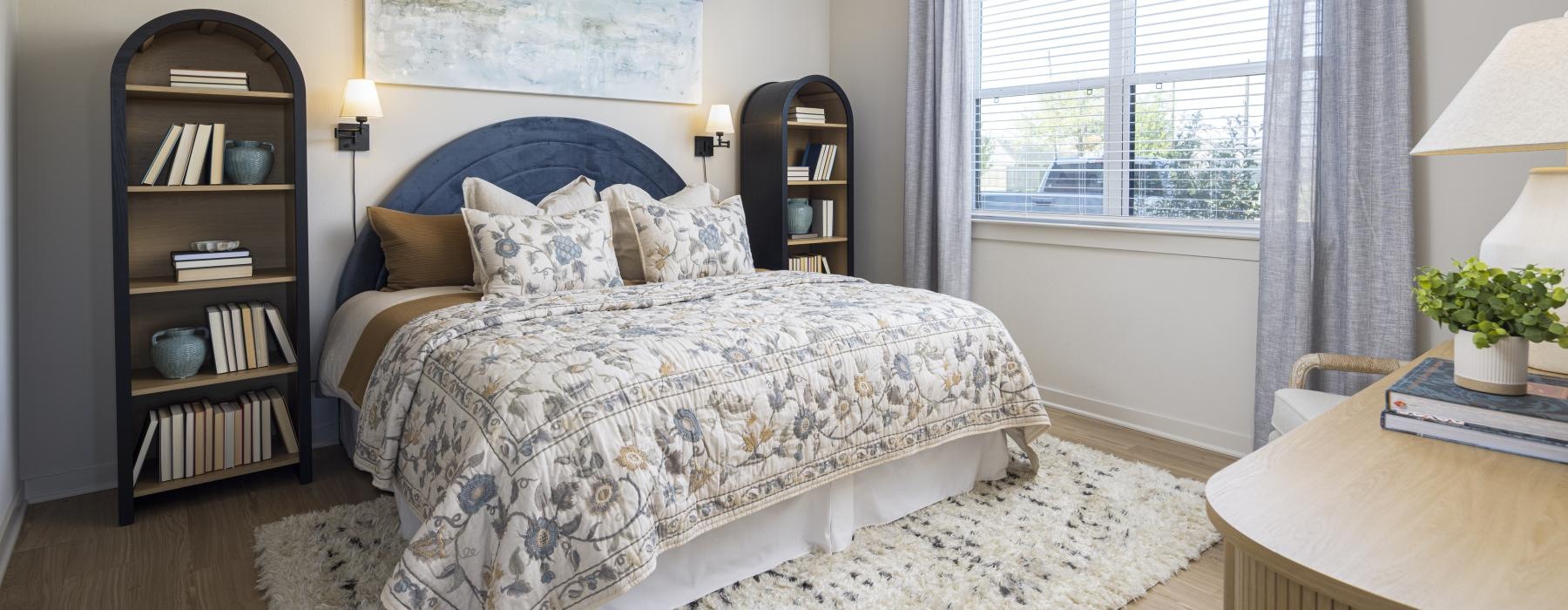 spacious bedroom with bookcases