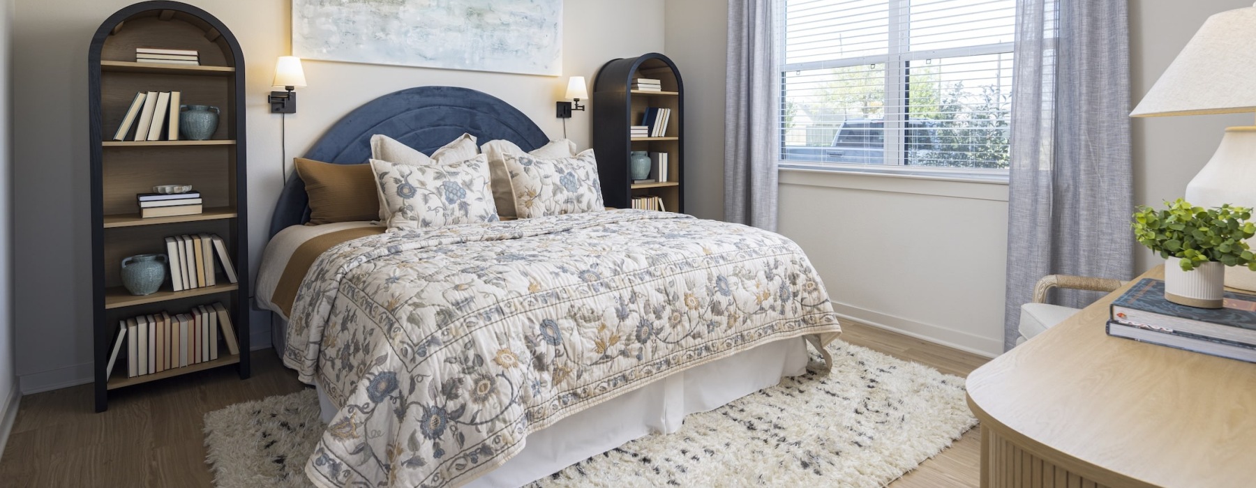 spacious bedroom with bookcases