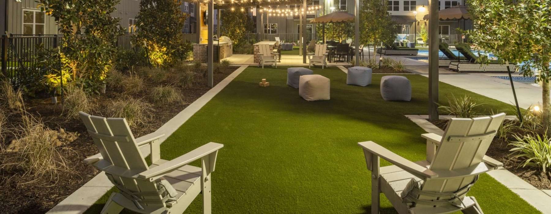 string lighting over lawn with chairs and cushions