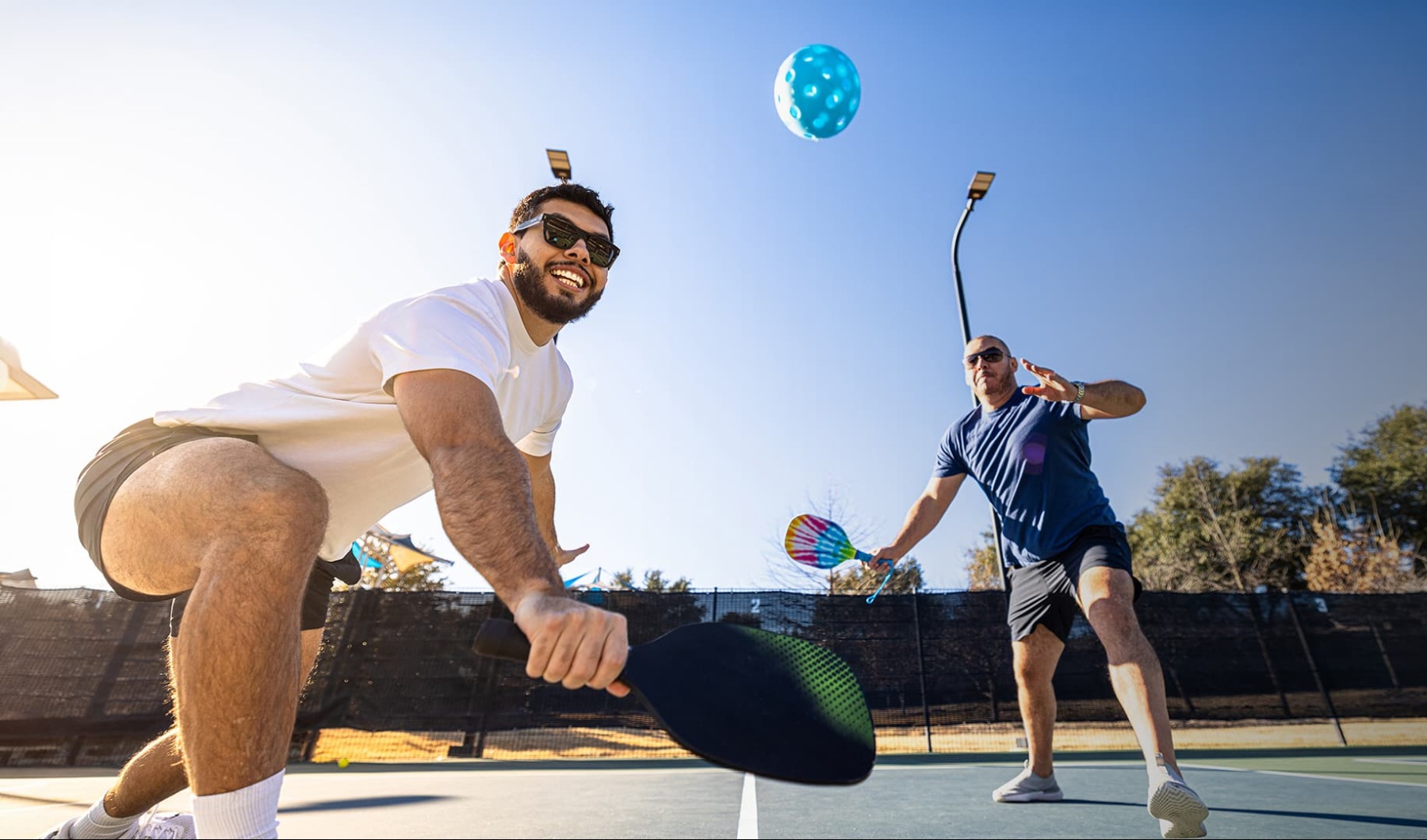 a couple of men playing ping pong